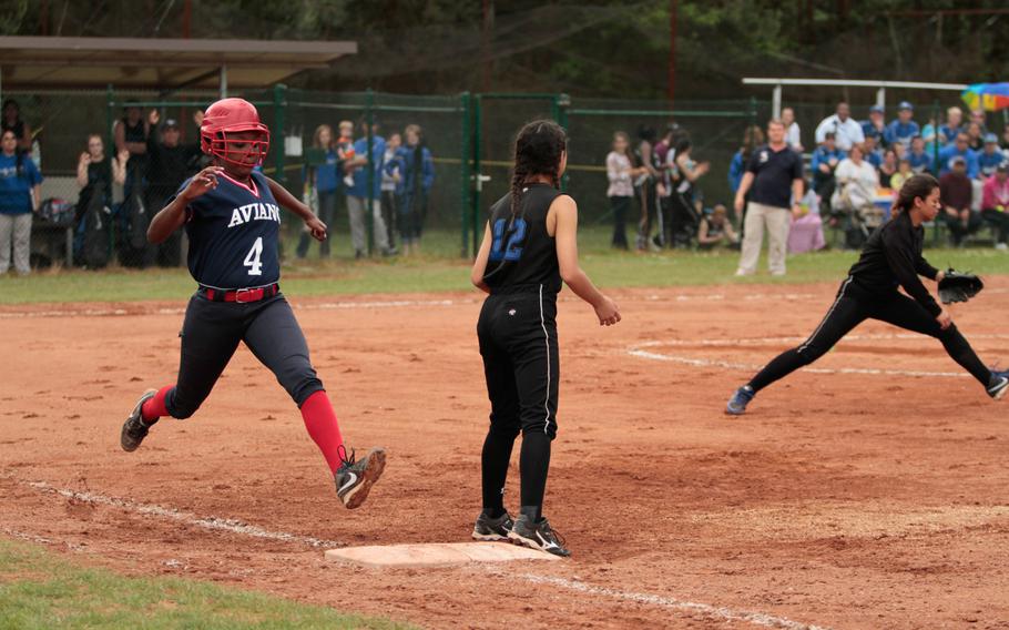 Aviano's Alexus Ferron glides into first on a single in the Saints' 10-3 loss Friday to Hohenfels in a quarterfinals match in the DODDS-Europe softball championships Friday. 