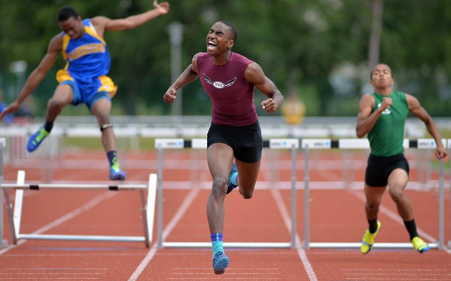 Vilseck's David Harris celebrates as he crosses the finish line in 40.31 seconds to win the 300-meter hurdles reach at the DODDS-Europe track and field championships in Kaiserslautern, Germany, Saturday, May 24, 2014.