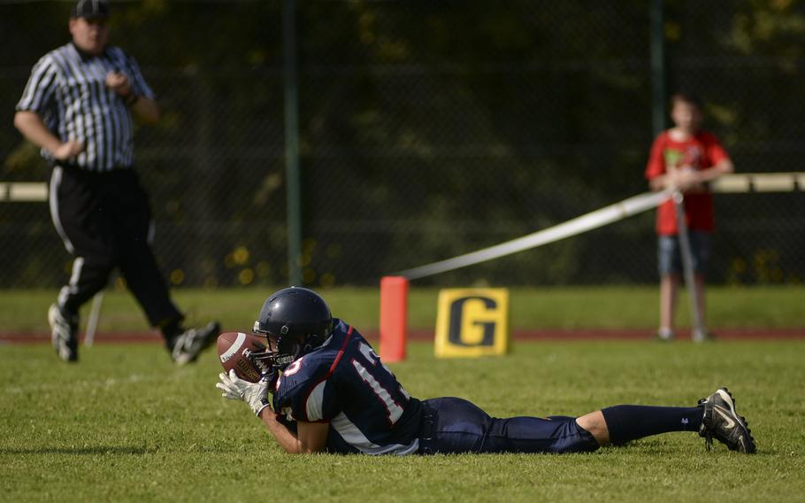 Bitburg's Colton Thomas loses his footing while adjusting to make an athletic reception to convert a two-point conversion against Baumholder Saturday afternoon, Sept. 6, 2014 in Bitburg. Bitburg defeated Baumholder 32-8.