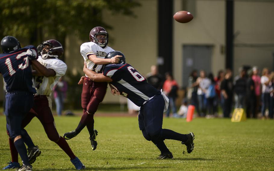 Bitburg's Alex Santiago Jr. disrupts a pass from Baumholder's Kameron Moore on a warm Saturday afternoon to kick off the football season at Bitburg Sept. 6, 2014. Bitburg defeated Baumholder 32-8.