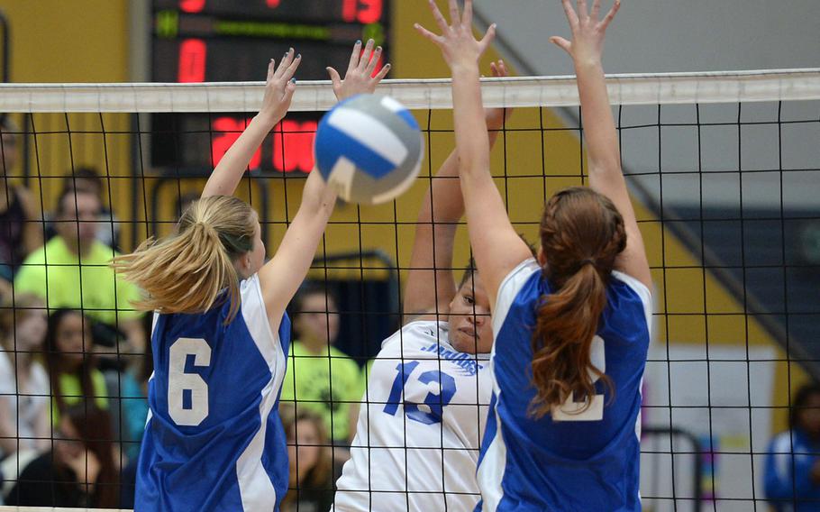 Sigonella's Sydney Moore, center, watches her spike split the Brussels defense in last season's  Division III final at the DODDS-Europe volleyball championships. Moore, named the tourney MVP for the division, will be back for the Jaguars  for the 2014 season that starts this weekend.