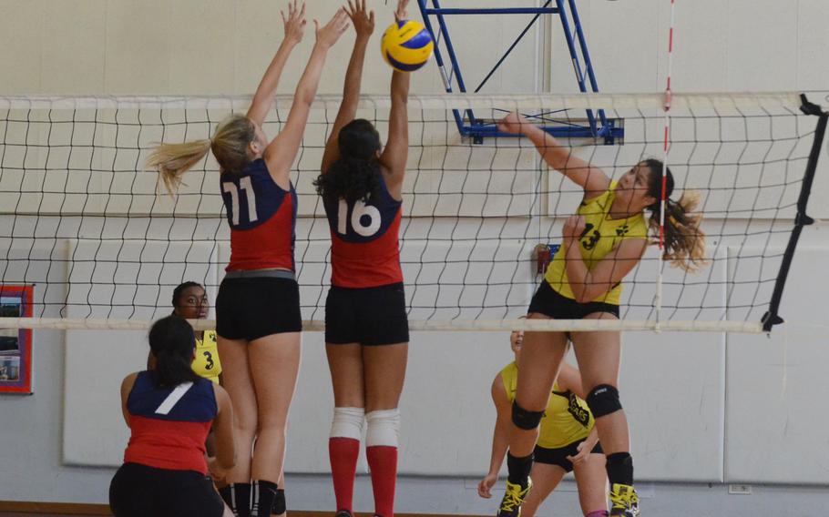 Vicenza's Soliyah Stevens-Ogaz sneaks a spike past Aviano defenders Saturday during a series of matches at Aviano Air Base, Italy. The Saints won two matches back-to-back, 3-1.
