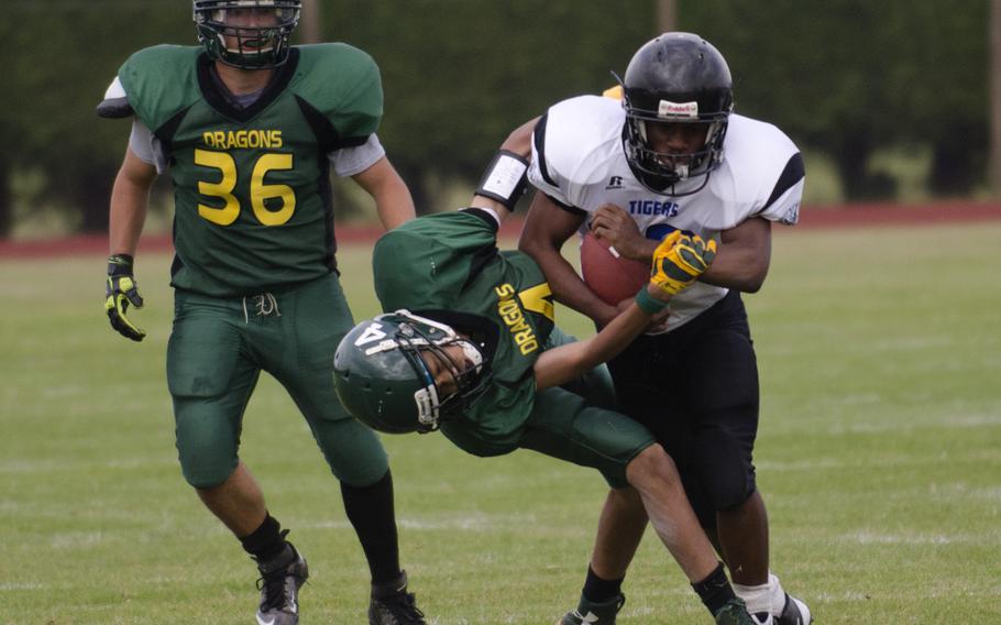 Alconbury's Forrest Booker tries to take down a Hohenfels player during a game at RAF Alconbury, England, on Saturday, Sept. 13, 2014. The game ended early in Hohenfels favor because of the mercy rule.
