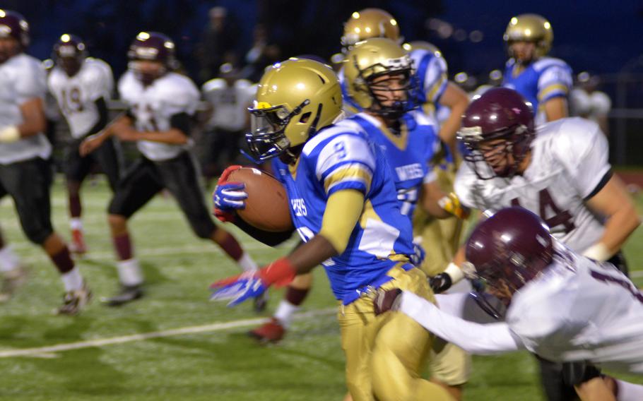 Wiesbaden's Deshon Barrow breaks free of the defense in a home game against Vilseck on Friday, Sept. 26, 2014.  The Warriors went on to beat the Falcons 32-17.