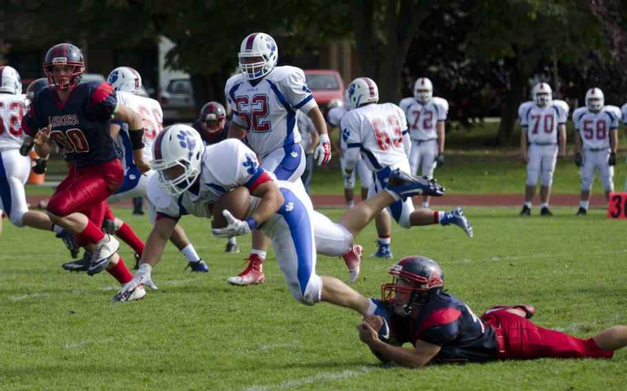 Ramstein's Ben Ciero is taken down by a Lakenheath foer during a football game on Saturday, Sept. 27, 2014, at RAF Lakenheath, England. Ciero scored a touchdown during the game.