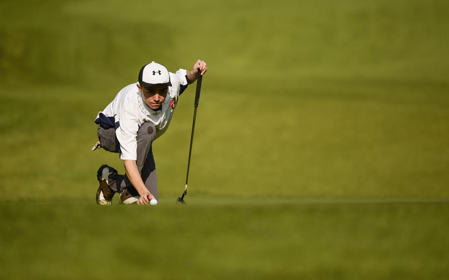 Ramstein's Cody Harden places his ball before a putt attempt Thursday, Oct. 2, 2014 during the last regular season DODDS-Europe golf tournament at the Rheinblick Golf Course in Wiesbaden, Germany.