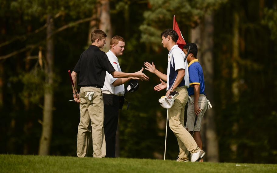 Patch's Jordan Holifield, far left, Kaiserslautern's Jeffery Kidwell, left middle, Ramstein's Joshua Davis, right front, and Wiesbaden's Jared Edwards shake hands Thursday, Oct. 2, 2014 after finishing the last regular season DODDS-Europe golf tournament at the Rheinblick Golf Course in Wiesbaden, Germany.