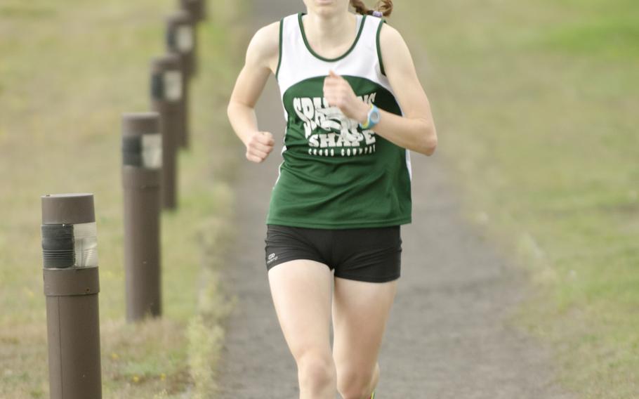 SHAPE's Anna Kyle runs her second lap Saturday, Oct. 4, 2014 during a cross-country meet at RAF Lakenheath, England. Kyle took first place in the girls meet with a time of 21 minutes, 56 seconds.