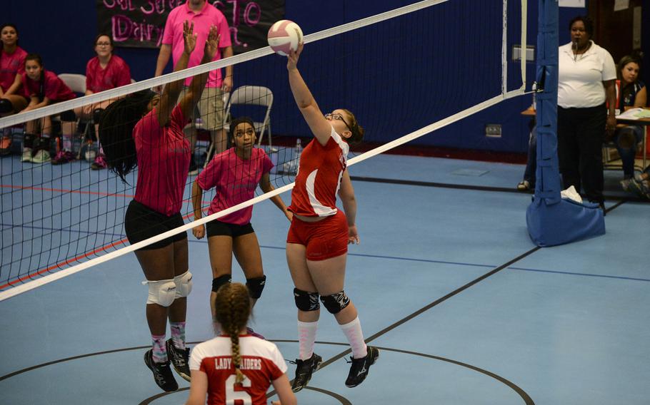 Kaiserslautern's Tia Hall pushes the ball over the net against Lakenheath's Kayla Langster Saturday, Oct. 4, 2014 during a volleyball match at Ramstein, Germany.