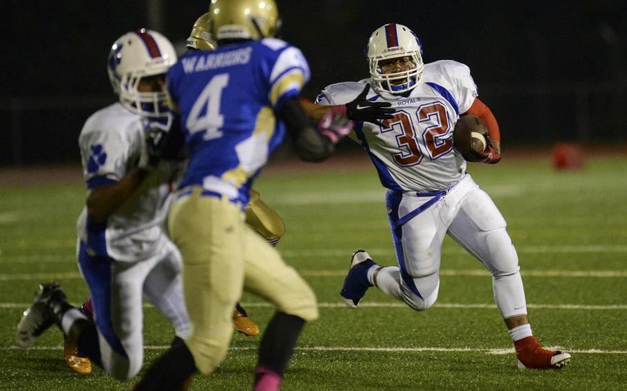 Ramstein's Donta Morris picks up a few yards Friday, Oct. 10, 2014, at Wiesbaden, Germany. Wiesbaden went on to win 20-14 in overtime.