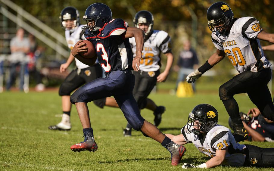 Bitburg's Curtiss Wilson breaks away from Vicenza defenders for a touchdown Saturday, Oct. 18, 2014, at Bitburg, Germany.