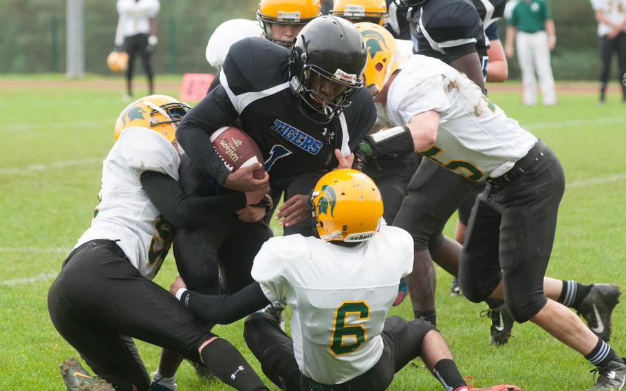 SHAPE's defense held strong through the first half, but gave up two major plays in the second that put them behind. Here, Spartan defenders swarm Hohenfels' A.J. Day during a DODDS-Europe Division II quarterfinals game, Oct. 18, 2014 at Hohenfels, Germany. 