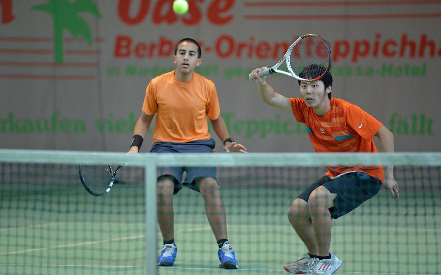 Bahrain's Frank Li, right, returns a Patch shot as teammate Moustafa Refai watches in a semifinal match at the DODDS-Europe tennis championships in Wiesbaden, Germany, Friday Oct. 24, 2014. The pair lost the close match 7-6 (7-5), 7-5.