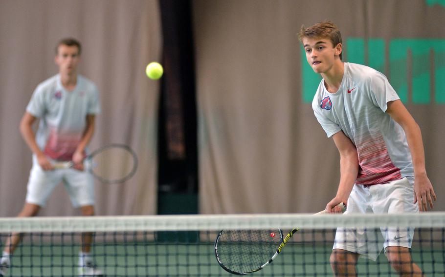 ISB's Bram Den Dekker, right,  knocks the ball over the net as teammate Maxime Dumortier watches in their semifinal match against Alconbury's Joseph Behr and Dylan Howorth at the DODDS-Europe tennis championships in Wiesbaden, Germany, Friday Oct. 24, 2014. The ISB duo won 6-2, 6-2 to advance to Saturday's final against Patch.