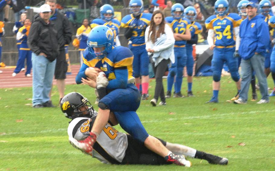 Vicenza's Dillon Williams tackles Ansbach's Tyler Benton in Ansbach's 32-12 victory Saturday at Gray Stadium in Ansbach, Germany. 