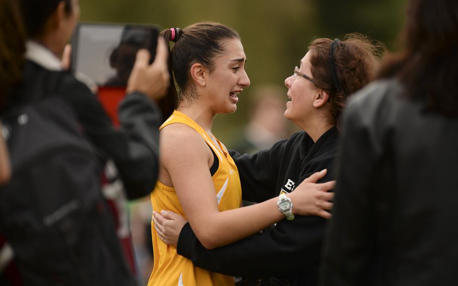 Patch's Kelleen McGuinness gets a hug from her mom, Lisa McGuinness, after finishing second at the DODDS-Europe cross country championship race at the Rolling Hills Golf Club in Baumholder, Germany, Saturday, Oct. 25, 2014.