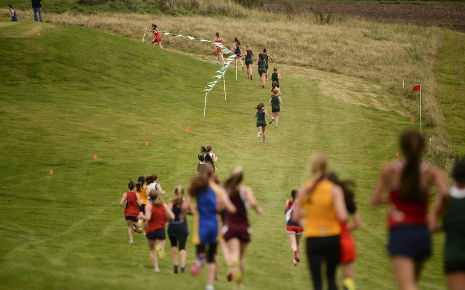 Racers cruise down a long hill at the Rolling Hills Golf Club in Baumholder, Germany during the DODDS-Europe cross country championship race, Saturday, Oct. 25, 2014.