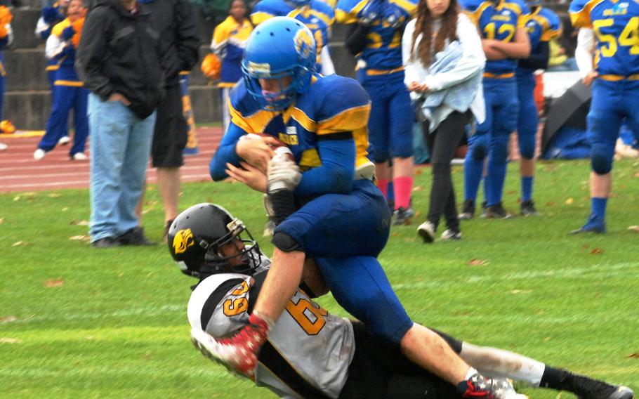 Vicenza's Dillon Williams tackles Ansbach's Tyler Benton in Ansbach's 32-12 victory Saturday at Gray Stadium in Ansbach, Germany.  Hohenfels will face Ansbach this Saturday, Nov. 1, 2014 to decide the DODDS-Europe Division II champions at Kaiserslautern, Germany.