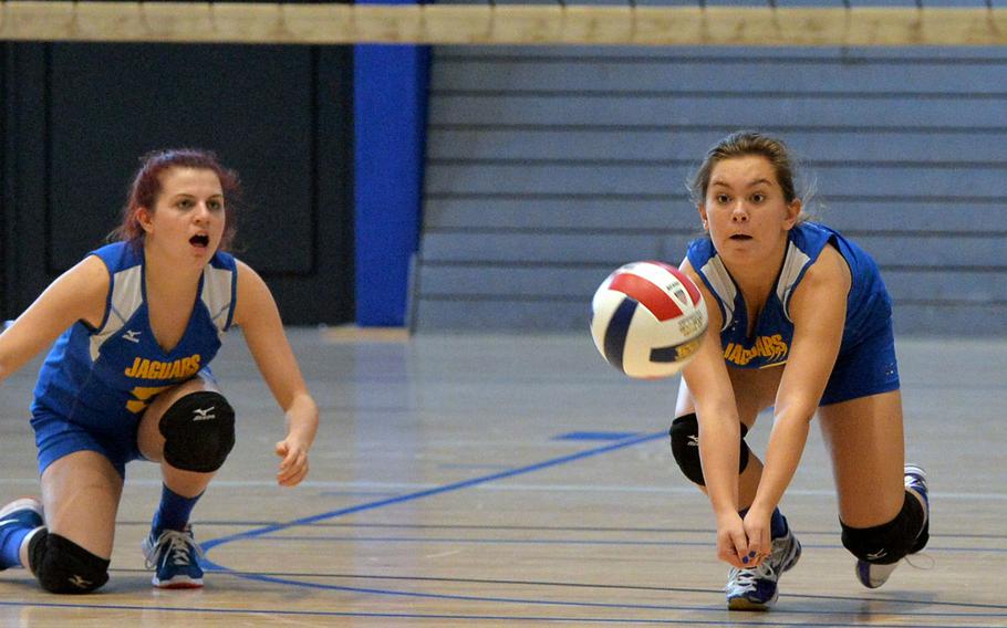 Sigonella's Kaitlyn Bean digs deep to get at a Menwith Hill serve as teammate Kendra Van Wynsberghe watches in opening day Division III action at the DODDS-Europe volleyball finals in Kaiserslautern, Germany, Thursday, Oct. 30, 2014. Sigonella won 20-25, 25-22, 15-11.