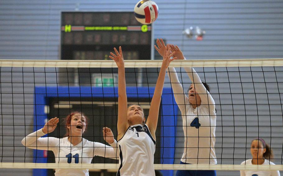 Florence's Natalia Consumi June, center knocks the ball backwards over the net against the defense of Incirlik's Brooke Wills, left, and Josie Broome in opening day Division III action at the DODDS-Europe volleyball finals in Kaiserslautern, Germany, Thursday, Oct. 30, 2014. Florence won 25-20, 21-25, 15-7.