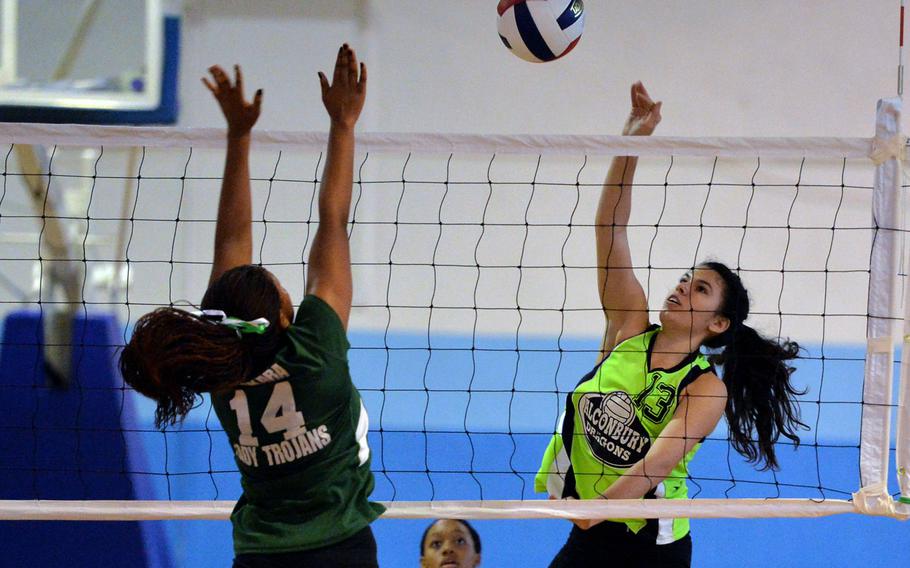 Alconbury's Reigha Barone, right hit the ball against Ankara's Nani Khumalo in opening day Division III action at the DODDS-Europe volleyball finals in Kaiserslautern, Germany, Thursday, Oct. 30, 2014. Alconbury won 25-13, 25-8.