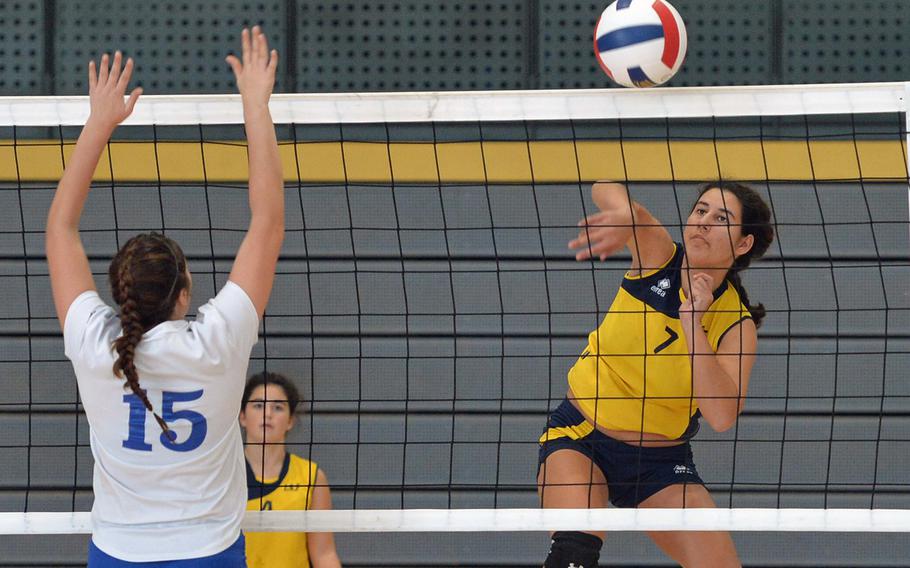Florence's Malaika Handa slams the ball across the net and past the Brussels defense including Laura Helbling, left, in a Division III match at the DODDS-Europe volleyball championships in Ramstein, Germany, Friday Oct. 31, 2014. Florence won 25-18, 25-16.