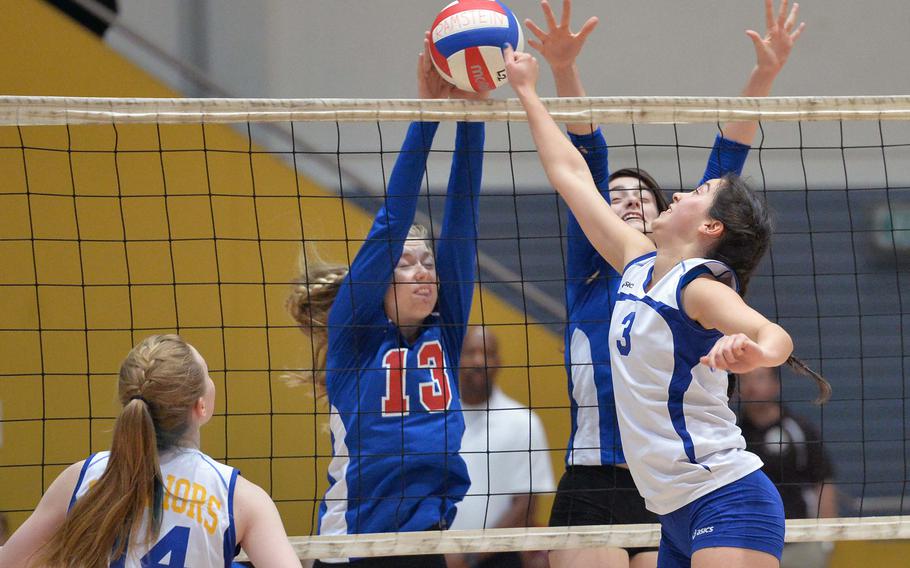 Ramstein's Sierra Nelson and Brittany Highley defend against Wiesbaden's Andriana Ibanez in a Division I semifinal at the DODDS-Europe volleyball championships in Ramstein Friday, Oct. 31, 2014. Wiesbaden won 25-22, 25-13,17-25,25-15 to advance to Saturday's final against Naples. Watching the action at left is Brigantia O'Sadnick