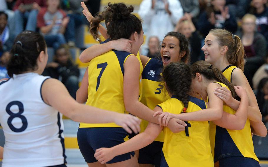 The International School of Florence Wild Boars celebrate their Division III title after defeating Sigonella 25-16, 25-21, 25-21 at the DODDS-Europe volleyball championships in Ramstein, Germany, Saturday, Nov. 1, 2014.
