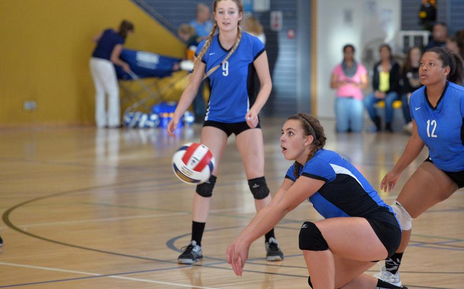 Rota's Tayla Irby digs out an Aviano serve as teammates Janae Curtice, left, and Jalaha Burton watch. Rota defeated Aviano 25-19, 25-18, 25-18 in the Division II final at the DODDS-Europe volleyball championships in Ramstein, Germany, Saturday, Nov. 2, 2014. 
