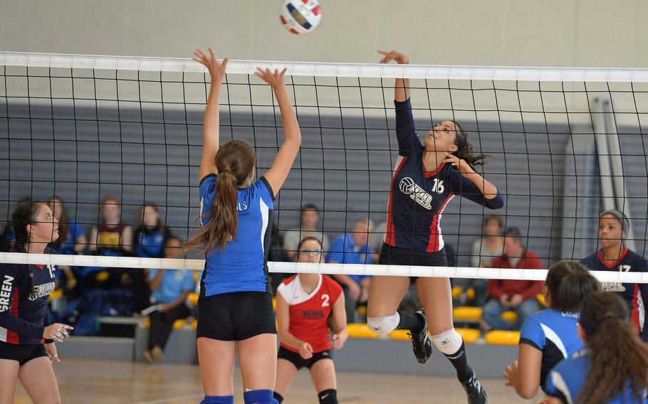 Aviano's Alana Masters hit the ball over the net against the defense of Rota's Triana Hampton in the Division II final at the DODDS-Europe volleyball championships in Ramstein, Germany, Saturday, Nov. 2, 2014. Rota won the match 25-19, 25-18, 25-18.