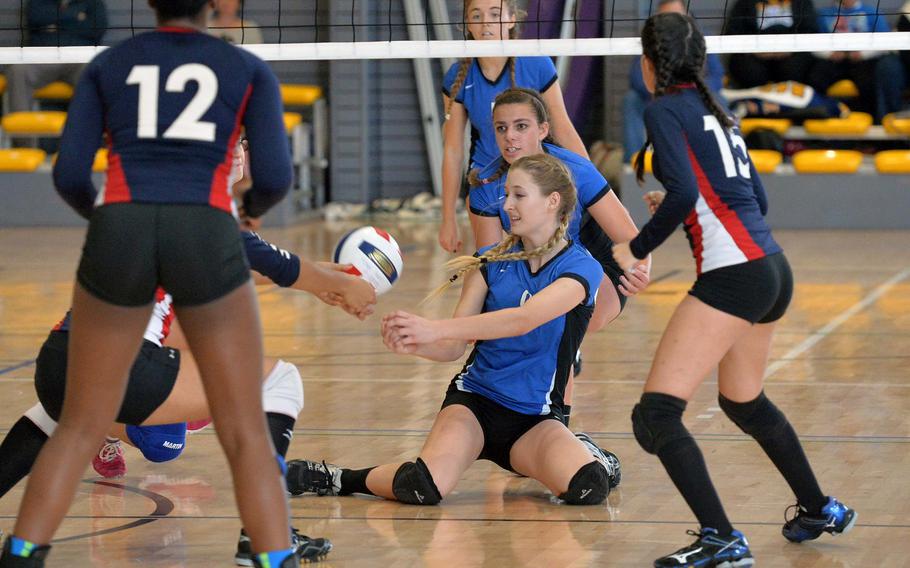 Rota's Janae Curtice goes to her knees as she tries to save a ball in the Division II final at the DODDS-Europe volleyball championships in Ramstein, Germany, Saturday, Nov. 2, 2014. Rota won the match 25-19, 25-19, 25-18. Teammates Tayla Irby and Tiffani Driscoll watch the action along with Aviano's Jasmine Cole, left, and Sydney Green.