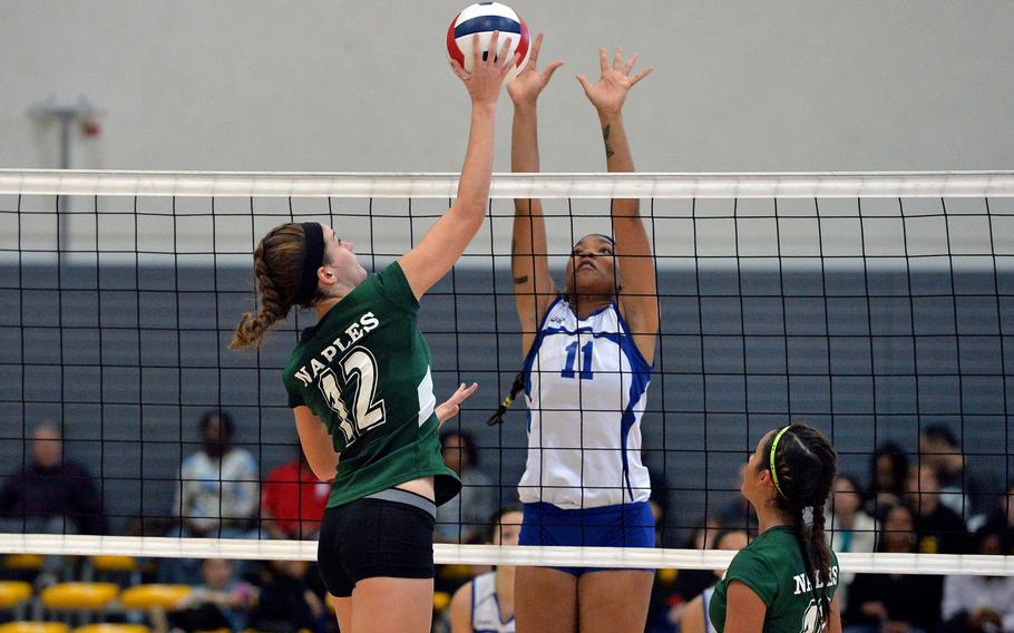 Jessica Wheeler, left,  hit the ball against Cierra Martin in the Division I final at the DODDS-Europe volleyball championships in Ramstein, Germany, Saturday, Nov. 1, 2014. Wiesbaden beat Naples 19-25, 25-11, 25-14, 23-25, 16-14. At right is Keylee Soto.