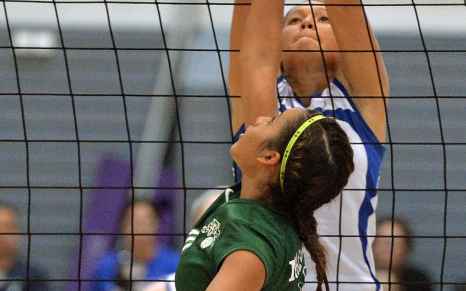 Keylee Soto of Naples and Wiesbaden's Leah Rojas battle at the net  in the Division I final at the DODDS-Europe volleyball championships in Ramstein, Germany, Saturday, Nov. 1, 2014. Wiesbaden beat Naples 19-25, 25-11, 25-14, 23-25, 16-14.