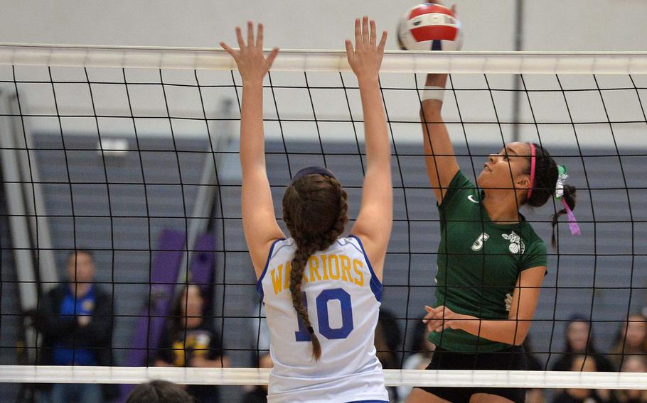 Naples Leina'ala Esperon hits the ball across the net against Wiesbaden's Mackinley Bullock in the Division I final at the DODDS-Europe volleyball championships in Ramstein, Germany, Saturday, Nov. 1, 2014. Wiesbaden beat Naples 19-25, 25-11, 25-14, 23-25, 16-14.