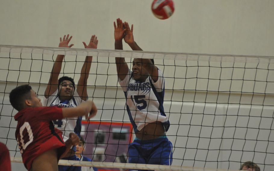 AOSR senior Gregory China watches  a spike get past Sigonella defenders Chris Moore, right, and Anthony Lastrella in the Falcons' 26-24, 25-19, 25-19 victory Saturday that earned them their third straight DODDS European Volleyball title.