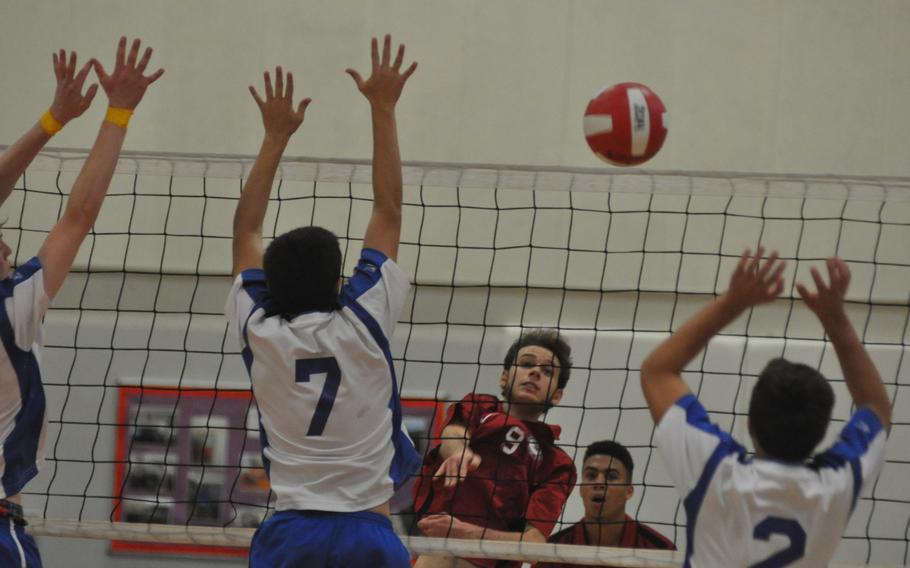 American Overseas School of Rome's Alessandro Elia watches his spike go past Sigonella defenders Zach DeSanto, left, and Cody Davidson in the Falcons' 26-24, 25-19, 25-19 victory Saturday.