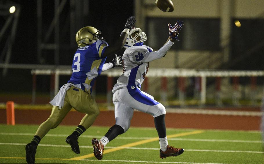 Ramstein's Malik Jackson pulls down a long pass in the 2014 DODDS-Europe DI football championship against Wiesbaden in Kaiserslautern, Germany, Nov. 1, 2014.