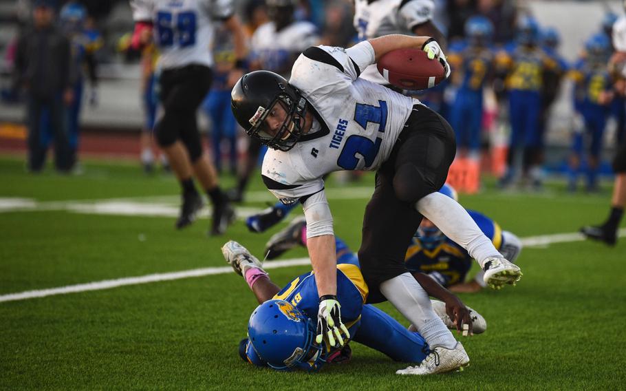 Hohenfels' David Vidovic runs over an Ansbach defender with a stiff arm in the 2014 DODDS-Europe DII football championship in Kaiserslautern, Germany, Nov. 1, 2014.