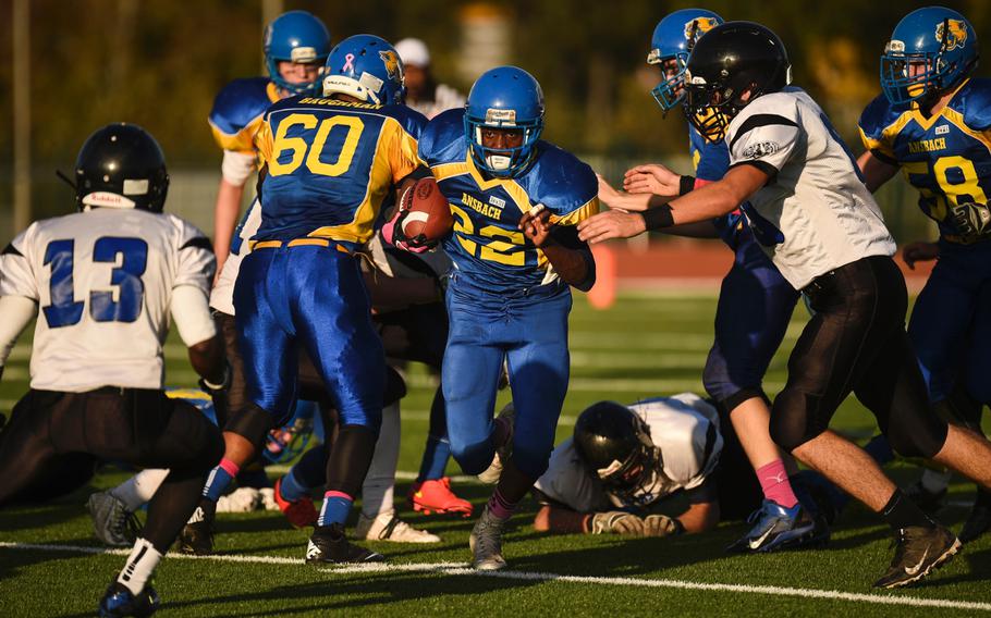 Ansbach's Roger Brownell picks up some yardage against Hohenfels in the 2014 DODDS-Europe DII football championship in Kaiserslautern, Germany, Nov. 1, 2014.