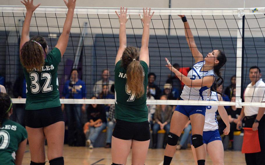 Wiesbaden's Leah Rojas, right, hits the ball against Skylar Evans, left, and Amanda James of Naples in the Division I final at the DODDS-Europe volleyball championships in Ramstein, Germany, Saturday, Nov. 1, 2014. Rojas has been named the Stars and Stripes volleyball Athlete of the Year.