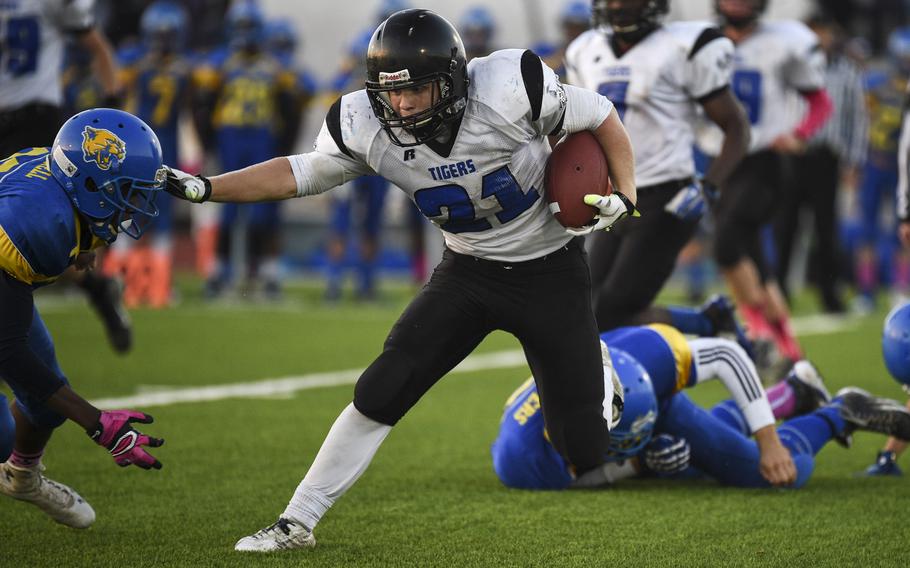 Hohenfels' David Vidovic stiff arms an Ansbach defender in the 2014 DODDS-Europe D-II football championship in Kaiserslautern, Germany, Nov. 1, 2014.

