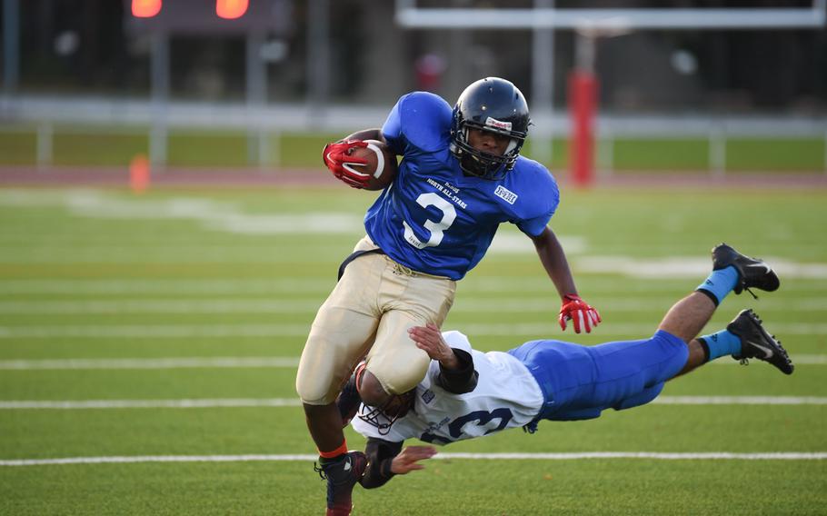 Bit burg's Curtiss Wilson, playing for North All-Stars, breaks a tackle on a run Saturday, Nov. 8, 2014, in the DODDS-Europe all-star game.