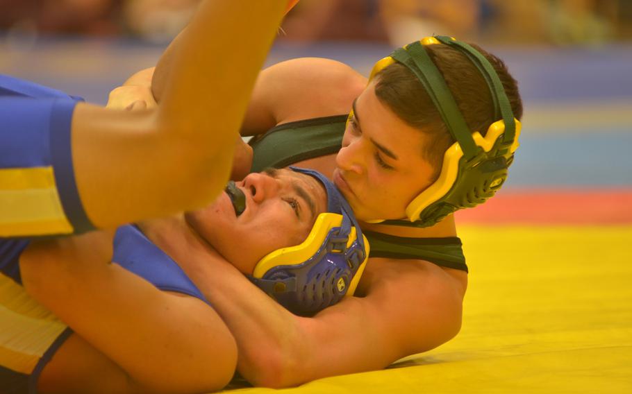 AFNORTH's Anthony Doerfer wrestles Wiesbaden's Henry Etheridge in the 113-pound weight class at a wrestling tournament Saturday, Dec. 13, 2014 in Wiesbaden, Germany.  Doerfer beat Etheridge and went on to take first place in his weight division.