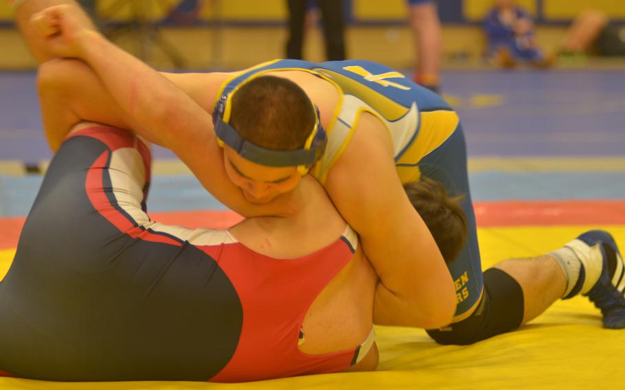220-pound champ Hunter Lunasin from Wiesbaden prepares Jakub Jackowski for a pin, which he accomplished in 27 seconds at a wrestling tournament Saturday, Dec. 13, 2014 in Wiesbaden, Germany.
