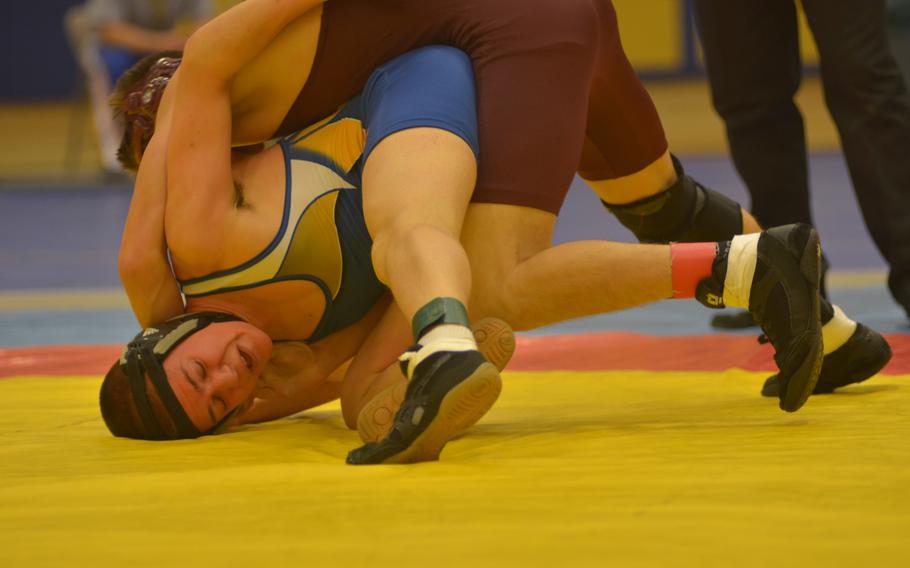Warriors' Caleb Magowan is inverted by Buccaneers' Terence Wilson in the 132-pound weight class at a wrestling tournament Saturday, Dec. 13, 2014 in Wiesbaden.  Magowan defeated Wilson but was eventually stopped by Barons' Brandon Beaumont for tops in the weight division.