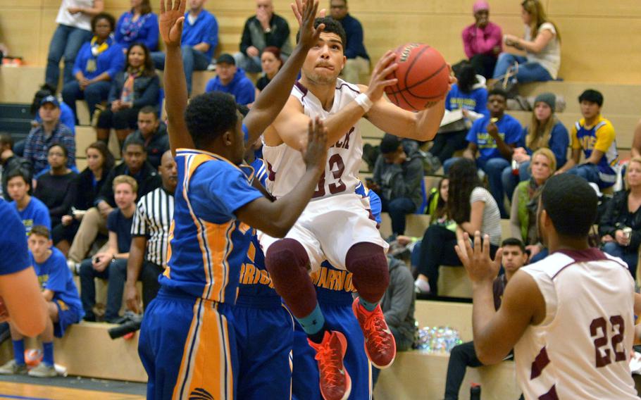 Vilseck's Gabriel Lewis aims for the basket as he goes in against a trio of Warriors led by Keyshaun Green, left. Wiesbaden beat Vilseck at home 56-44, Saturday, Jan.10, 2015.