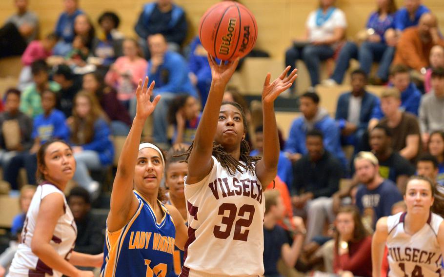 Vilseck's Marquita Morris shoots after getting past Wiesbaden's Sydney Hill in a game at Wiesbaden, Saturday, Jan.10, 2015. The home team won 31-21.