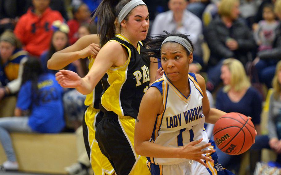 Wiesbaden's Cierra Martin goes in for a basket against Patch's Jaxen Godfrey in the Warriors' 40-16 win over the Panthers in Wiesbaden, Friday, Jan. 16, 2015.