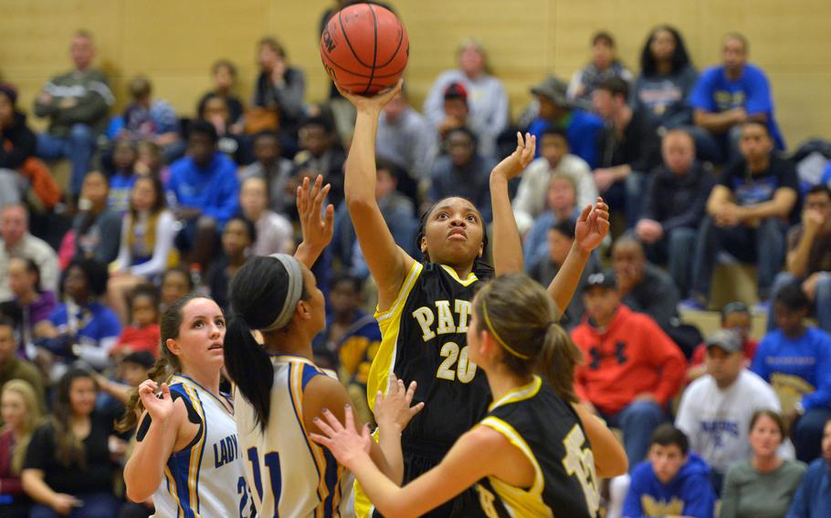 Patch's Treshon Jenkins, shoots over Wiesbaden's Cierra Martin in a Friday night game at Wiesbaden, Jan. 16, 2015. The home team won the game 40-16.