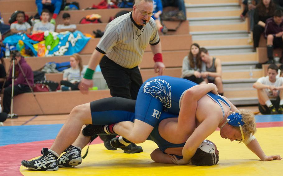 Ramstein's Clayton Artese rolls over Hohenfels' Connor Gibson during their matchup during the wrestling meet at Vilseck High School, Jan. 23, 2015. 